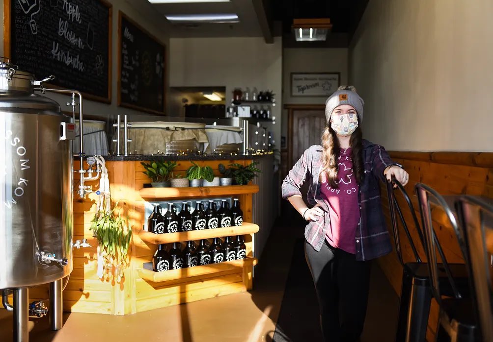 Caley Gunthorpe standing in Apple Blossom Kombucha taproom.